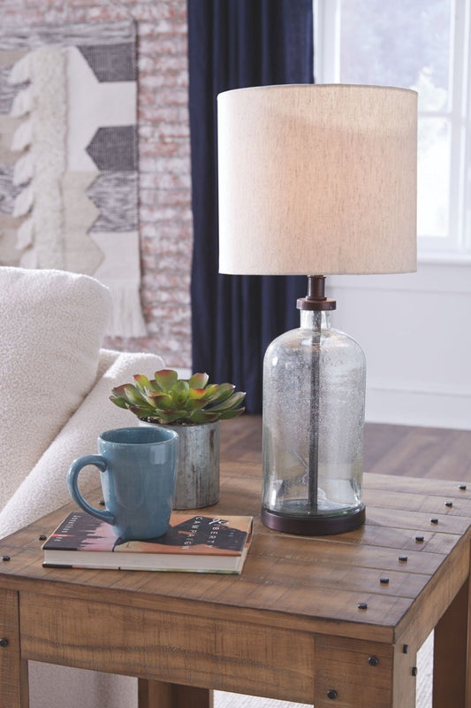 Bandile - Glass Table Lamp - Clear / Bronze Finish Table Lamps by Signature Design by Ashley® - Walls Furniture & Mattress