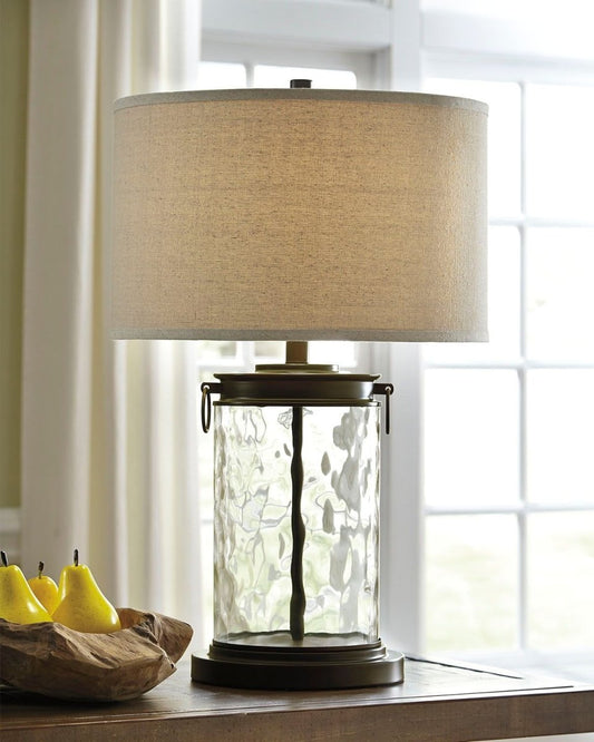 Tailynn - Glass Table Lamp - Clear / Bronze Finish Table Lamps by Signature Design by Ashley® - Walls Furniture & Mattress