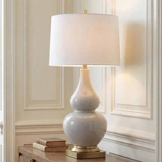 Weswick - Ceramic Table Lamp - Cream / Gold Finish Table Lamps by Signature Design by Ashley® - Walls Furniture & Mattress