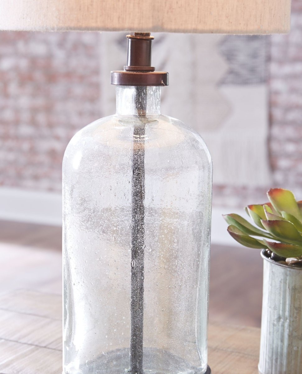 Bandile - Glass Table Lamp - Clear / Bronze Finish Table Lamps by Signature Design by Ashley® - Walls Furniture & Mattress