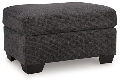 Loreo - Ottoman - Ebony Upholstered Ottomans by Benchcraft® - Walls Furniture & Mattress