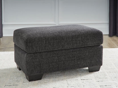 Loreo - Ottoman - Ebony Upholstered Ottomans by Benchcraft® - Walls Furniture & Mattress