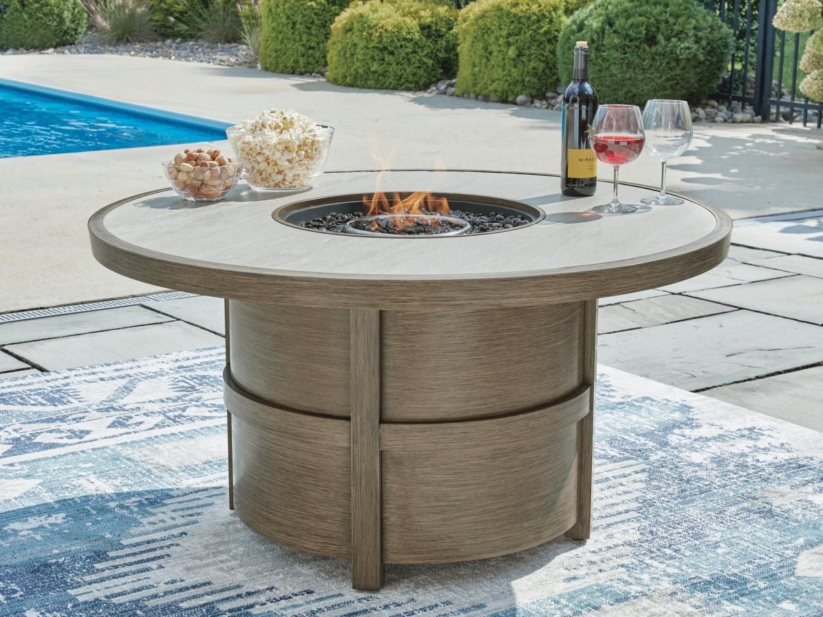 Rainier Ranch - Round Fire Pit Table - Beige Fire Pits by Signature Design by Ashley® - Walls Furniture & Mattress