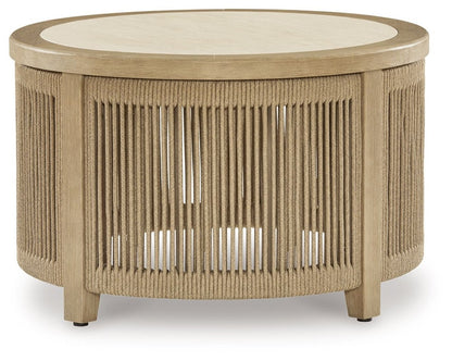 Spooners Cove - Round Cocktail Table - Beige Coffee Tables by Signature Design by Ashley® - Walls Furniture & Mattress